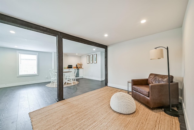 living room with recessed lighting, baseboards, and wood finished floors