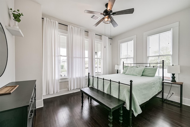 bedroom featuring visible vents, baseboards, ceiling fan, and dark wood-style floors