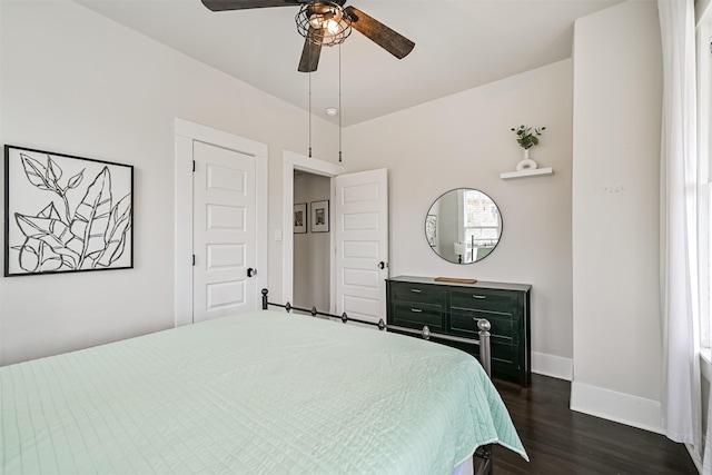 bedroom featuring dark wood-style flooring, baseboards, and ceiling fan