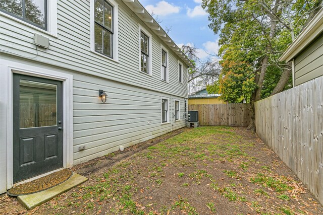 view of yard with cooling unit and a fenced backyard