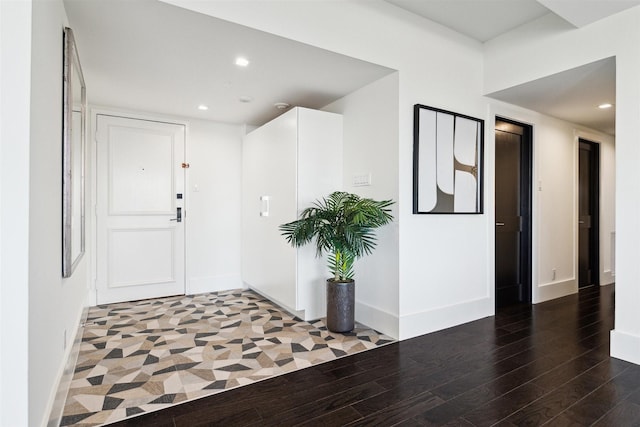 entrance foyer with visible vents, baseboards, recessed lighting, and wood finished floors