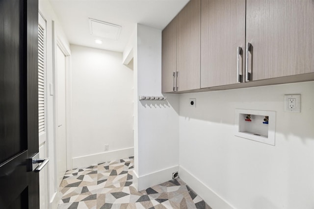 clothes washing area featuring cabinet space, baseboards, electric dryer hookup, and hookup for a washing machine