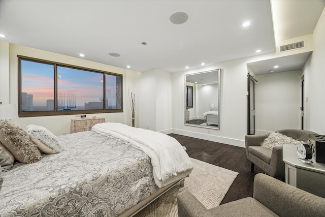 bedroom with wood finished floors, baseboards, visible vents, and recessed lighting