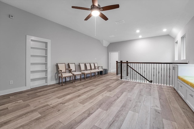 living area featuring visible vents, a ceiling fan, light wood finished floors, and vaulted ceiling