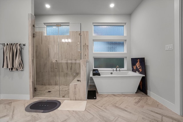 bathroom featuring a shower stall, recessed lighting, a freestanding tub, and baseboards