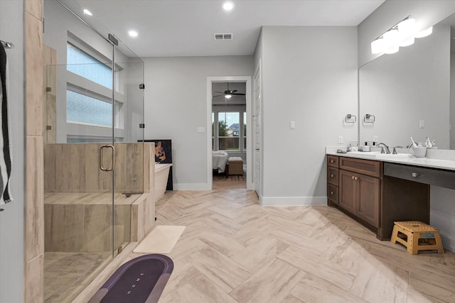 bathroom featuring visible vents, vanity, a stall shower, and baseboards