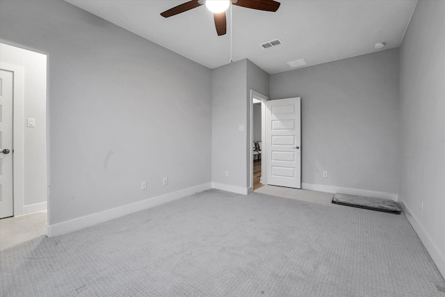 unfurnished room featuring visible vents, a ceiling fan, carpet flooring, and baseboards