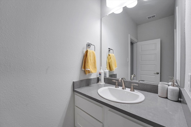 bathroom with visible vents and vanity