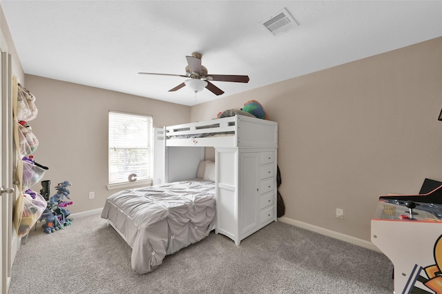 bedroom with ceiling fan, light colored carpet, baseboards, and visible vents