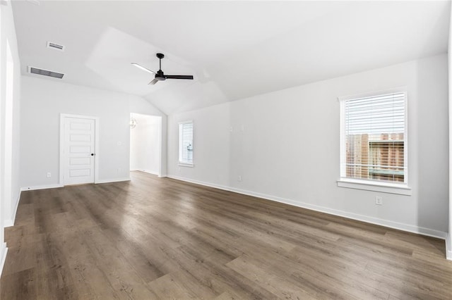 empty room featuring visible vents, a wealth of natural light, ceiling fan, and vaulted ceiling