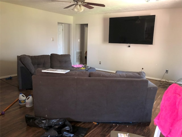 living room with visible vents, baseboards, wood finished floors, and ceiling fan