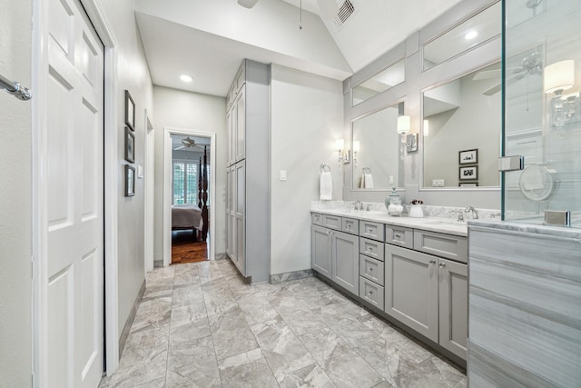 ensuite bathroom with a ceiling fan, visible vents, a sink, lofted ceiling, and double vanity