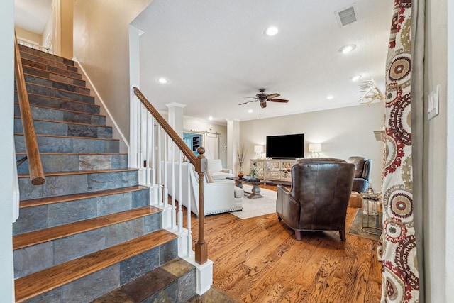 stairway featuring recessed lighting, visible vents, a ceiling fan, and wood finished floors