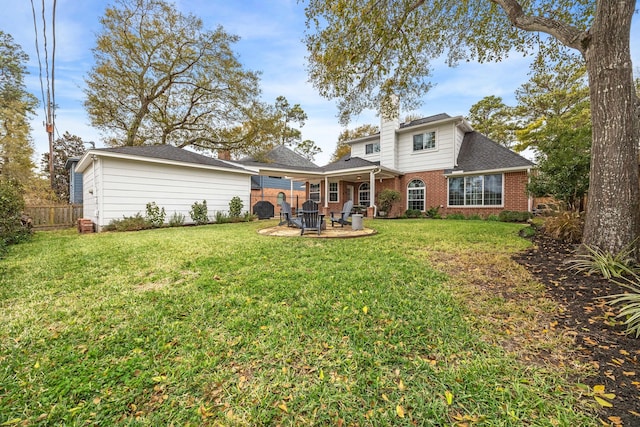 back of house with fence, brick siding, a chimney, and a lawn