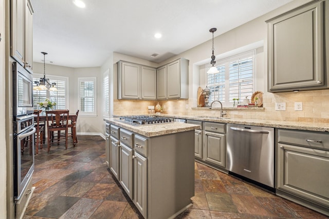 kitchen with a sink, gray cabinets, a wealth of natural light, and stainless steel appliances