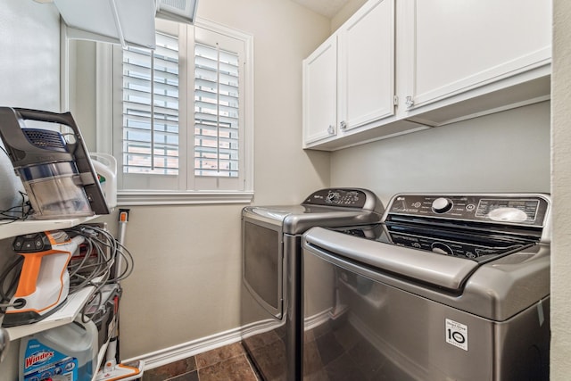 laundry area with cabinet space, independent washer and dryer, and baseboards