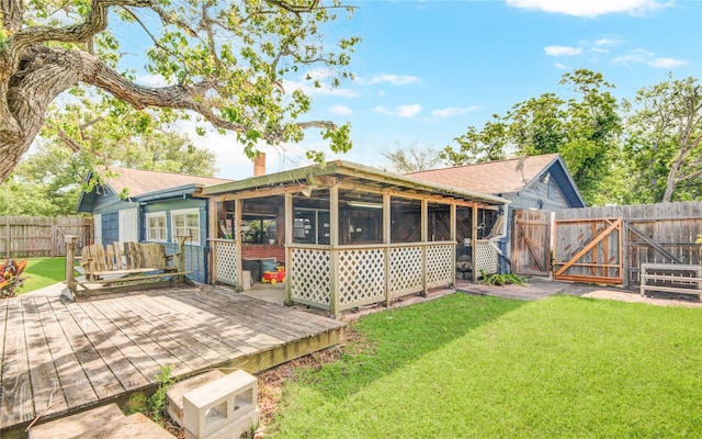 back of house with a sunroom, a yard, a fenced backyard, a gate, and a chimney