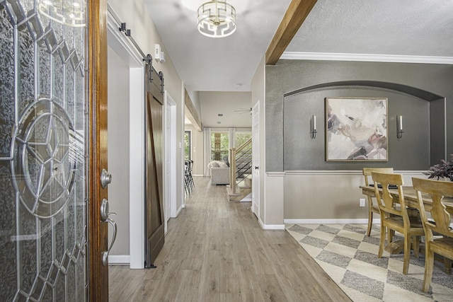 17939 Channel Hill Dr, Cypress, TX 77433 - entryway with a barn door, a textured ceiling, stairway, wainscoting, and wood finished floors