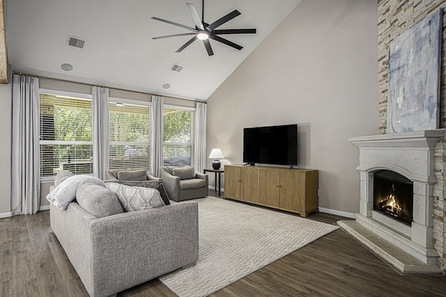17939 Channel Hill Dr, Cypress, TX 77433 - living room featuring high vaulted ceiling, visible vents, a warm lit fireplace, and ceiling fan