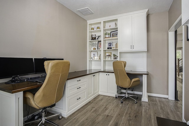17939 Channel Hill Dr, Cypress, TX 77433 - office with built in desk, visible vents, baseboards, and wood finished floors