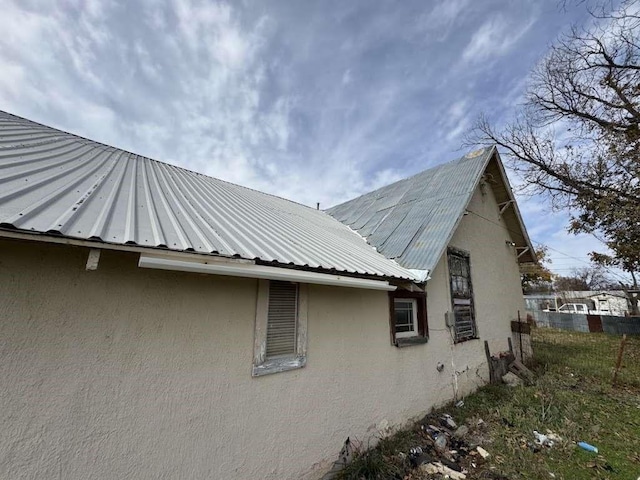 view of home's exterior with metal roof and stucco siding