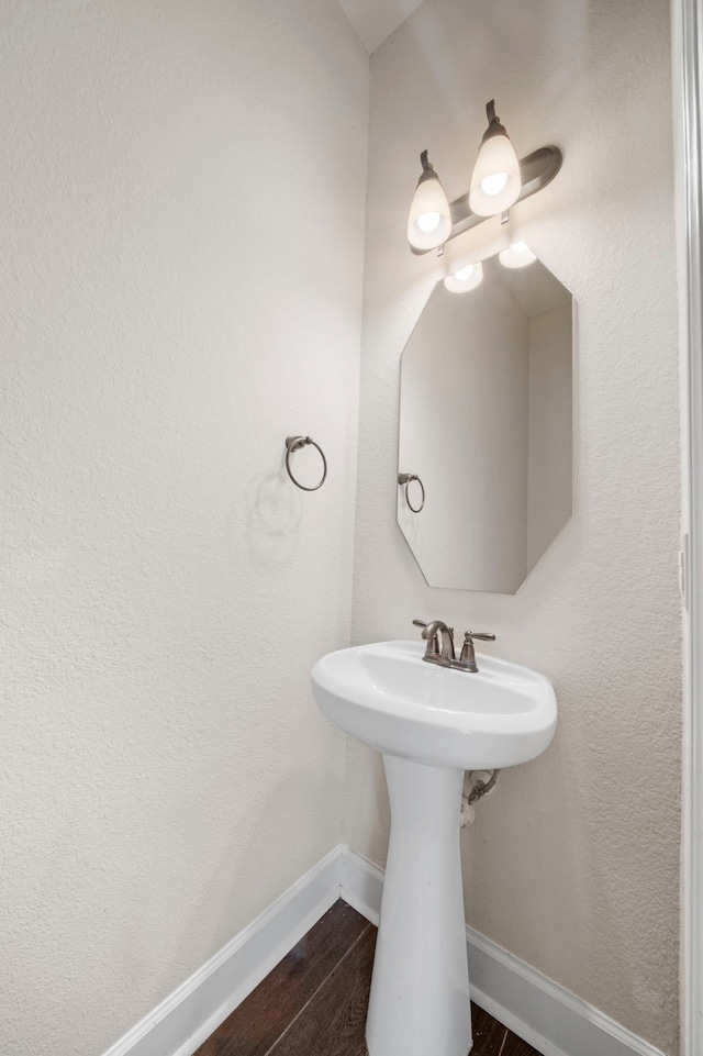 bathroom featuring baseboards and wood finished floors