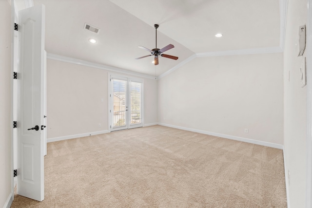 unfurnished room featuring vaulted ceiling, ornamental molding, light carpet, a ceiling fan, and visible vents