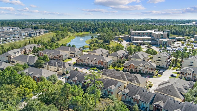 drone / aerial view with a water view and a residential view