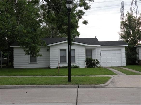 5600 Community Dr, Houston, TX 77005 - ranch-style home with an attached garage, concrete driveway, and a front yard