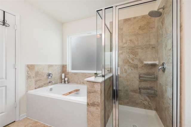 full bath featuring a garden tub and a shower stall