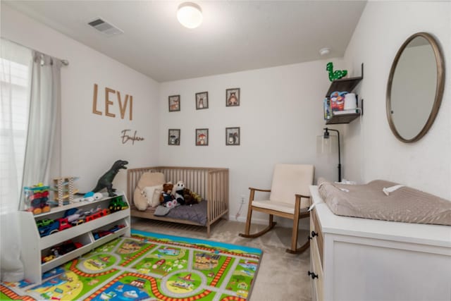 bedroom with light colored carpet and visible vents