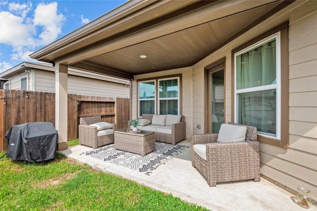 view of patio featuring fence, a grill, and outdoor lounge area