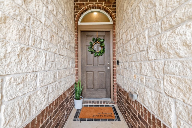 entrance to property with brick siding