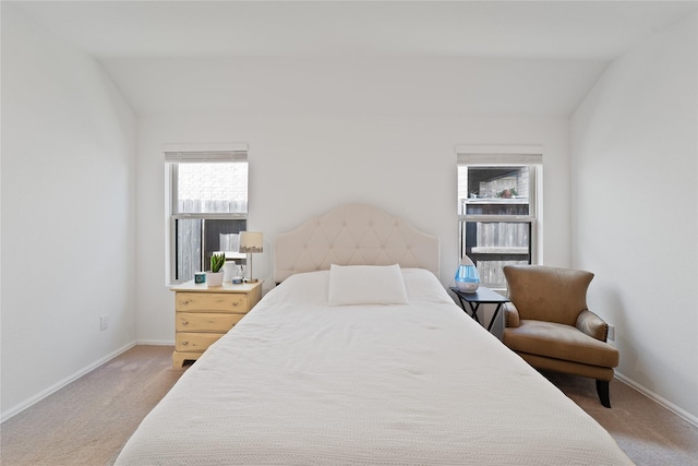 bedroom with light carpet, baseboards, and vaulted ceiling