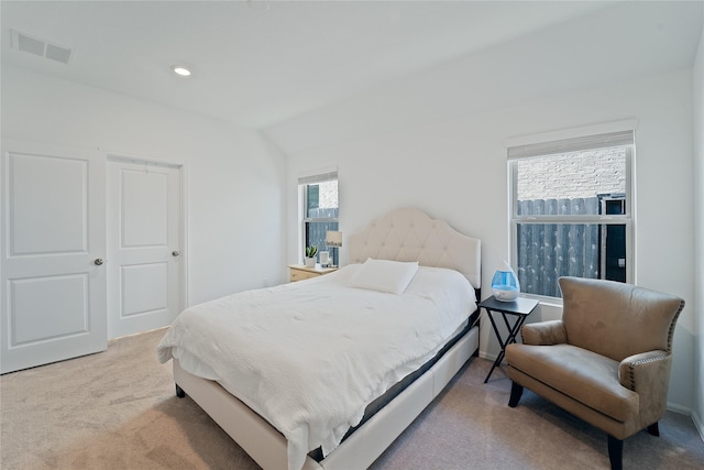 bedroom with visible vents, lofted ceiling, carpet, and recessed lighting