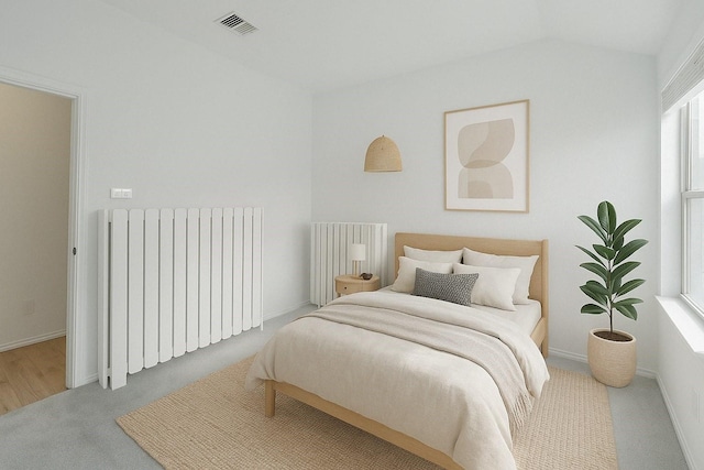 bedroom featuring visible vents, radiator, vaulted ceiling, radiator heating unit, and carpet flooring
