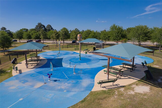 view of swimming pool featuring a yard and fence