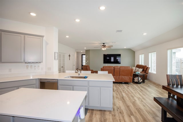 4411 Aspen Colony Ln, Baytown, TX 77521 - kitchen with a peninsula, stainless steel dishwasher, a sink, gray cabinets, and light countertops