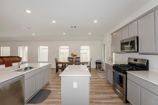 4411 Aspen Colony Ln, Baytown, TX 77521 - kitchen featuring stainless steel appliances, a sink, a wealth of natural light, visible vents, and gray cabinets