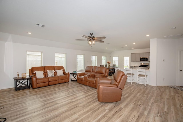 4411 Aspen Colony Ln, Baytown, TX 77521 - living room with light wood-type flooring, a ceiling fan, and visible vents