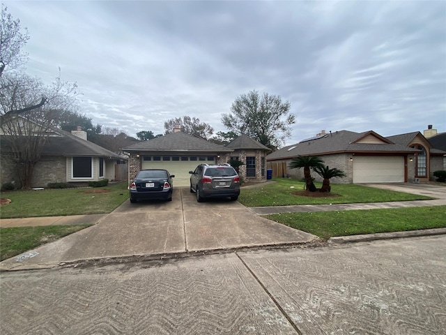 view of front facade featuring driveway, a front lawn, brick siding, and a garage