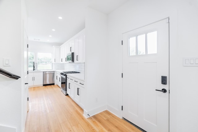 interior space with light wood-style flooring and recessed lighting