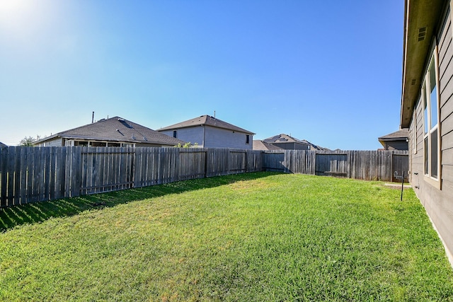 view of yard featuring a fenced backyard