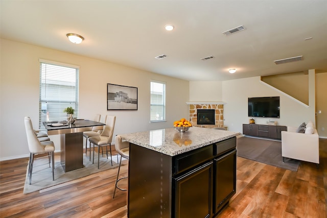 kitchen with wood finished floors, visible vents, and plenty of natural light