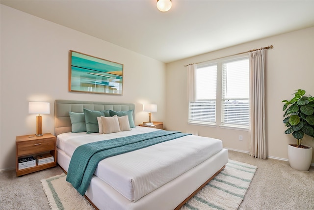 carpeted bedroom with baseboards
