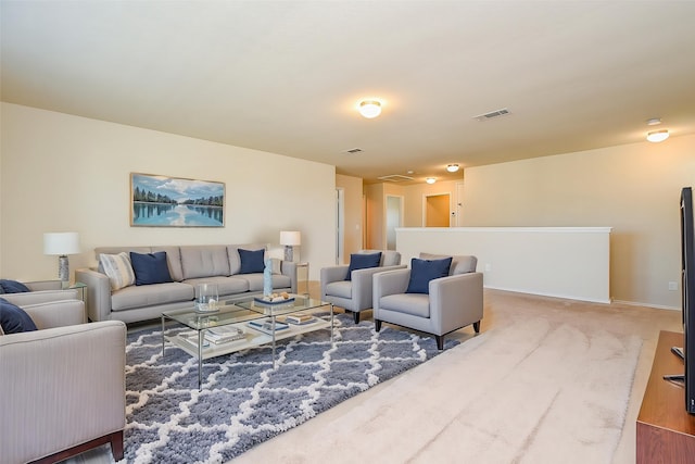 living area with visible vents, baseboards, and carpet floors