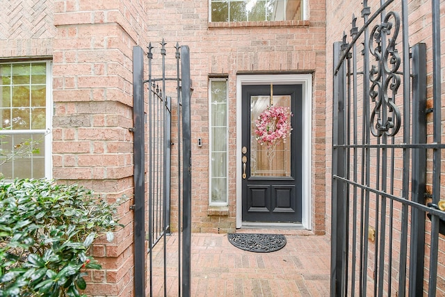 entrance to property featuring brick siding