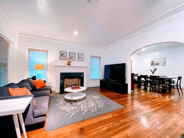1964 Norfolk St, Houston, TX 77098 - living area featuring ornamental molding, arched walkways, wood finished floors, and a premium fireplace