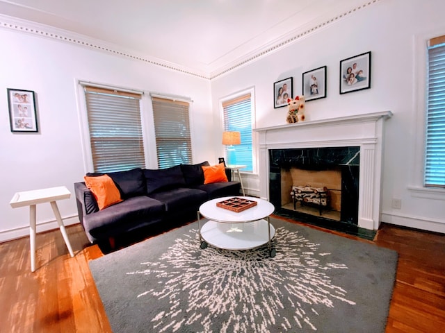 1964 Norfolk St, Houston, TX 77098 - living room featuring wood finished floors, healthy amount of natural light, a premium fireplace, baseboards, and crown molding