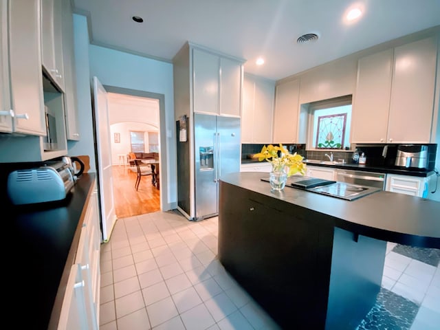 1964 Norfolk St, Houston, TX 77098 - kitchen featuring high end refrigerator, light tile patterned flooring, dark countertops, dishwasher, and recessed lighting